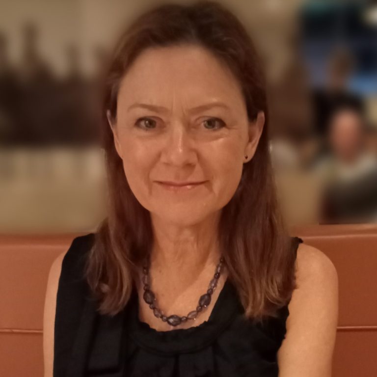 Woman with long brown hair wearing black top